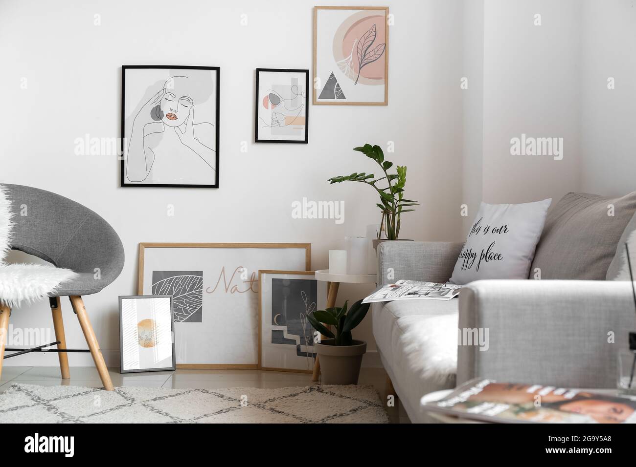 Interior of stylish living room with pictures Stock Photo - Alamy