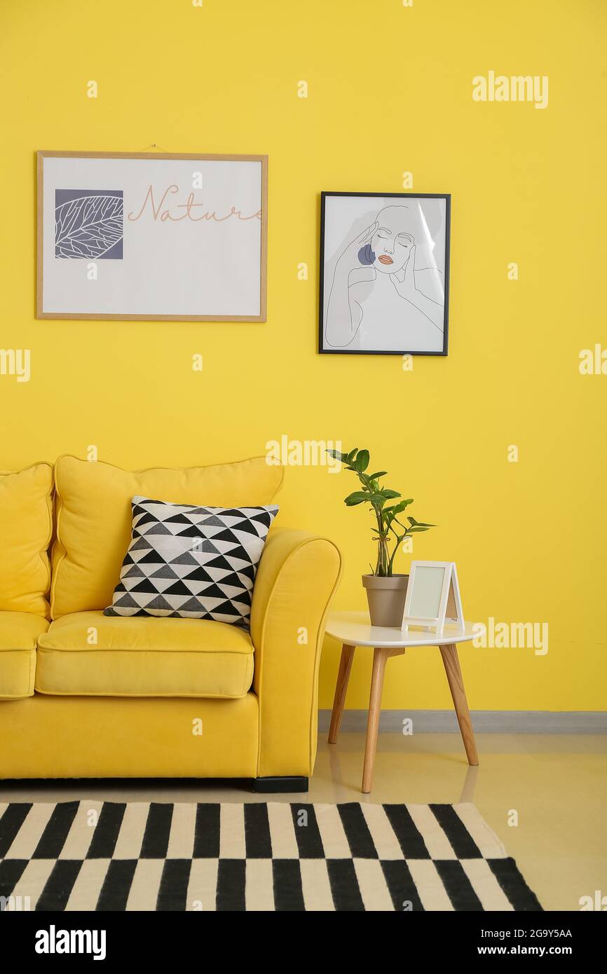Interior of stylish living room with pictures Stock Photo - Alamy
