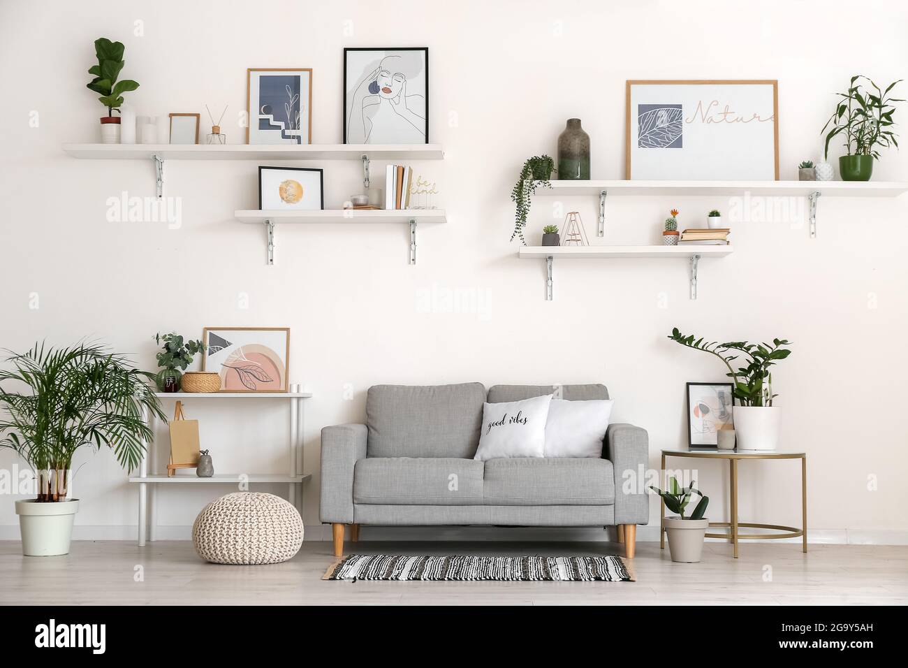 Interior of stylish living room with pictures Stock Photo - Alamy