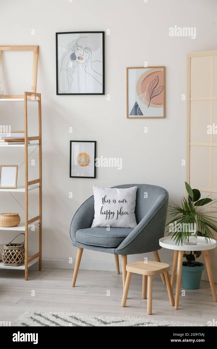 Interior of stylish living room with pictures Stock Photo - Alamy