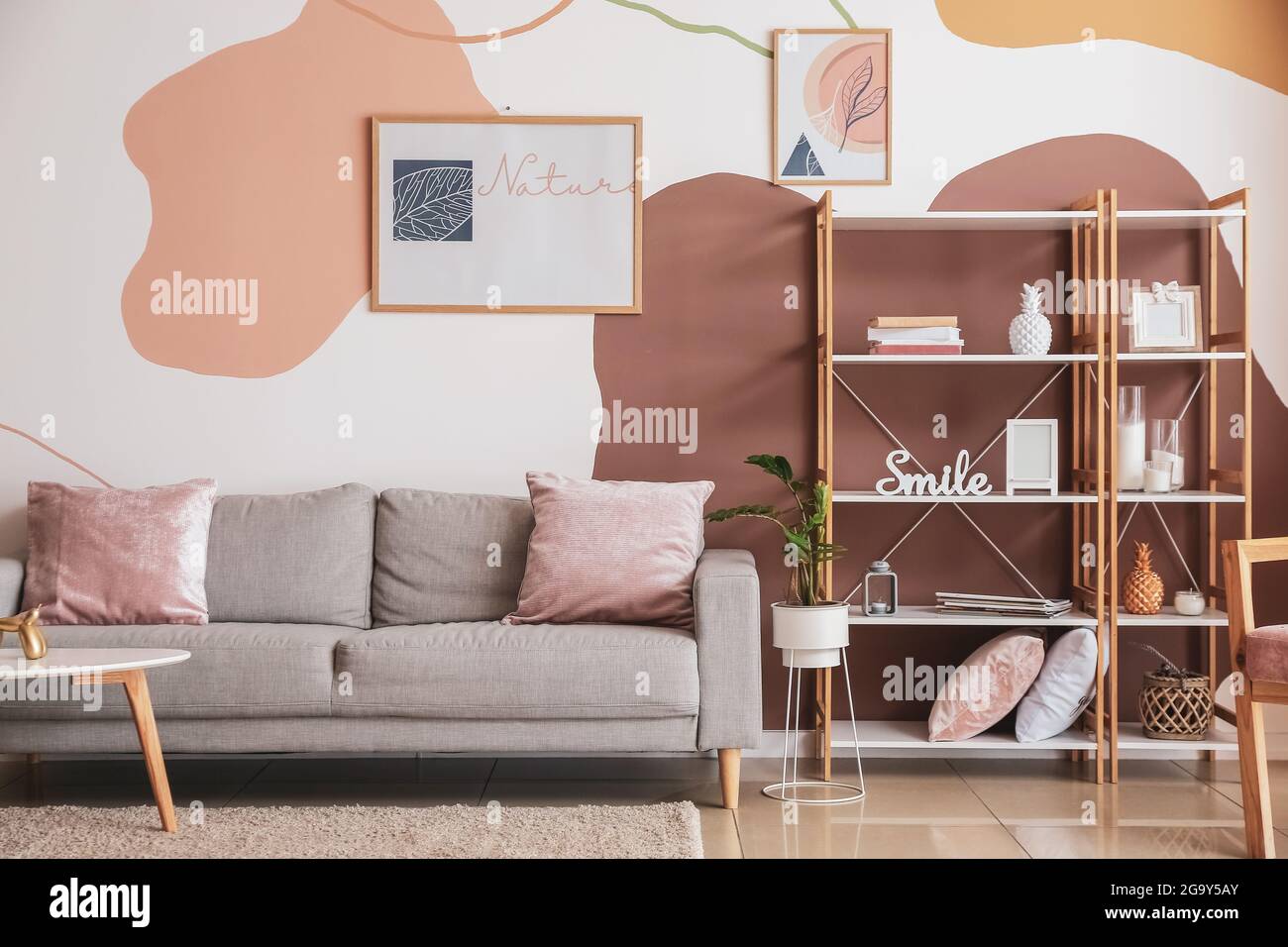 Interior of stylish living room with pictures Stock Photo - Alamy