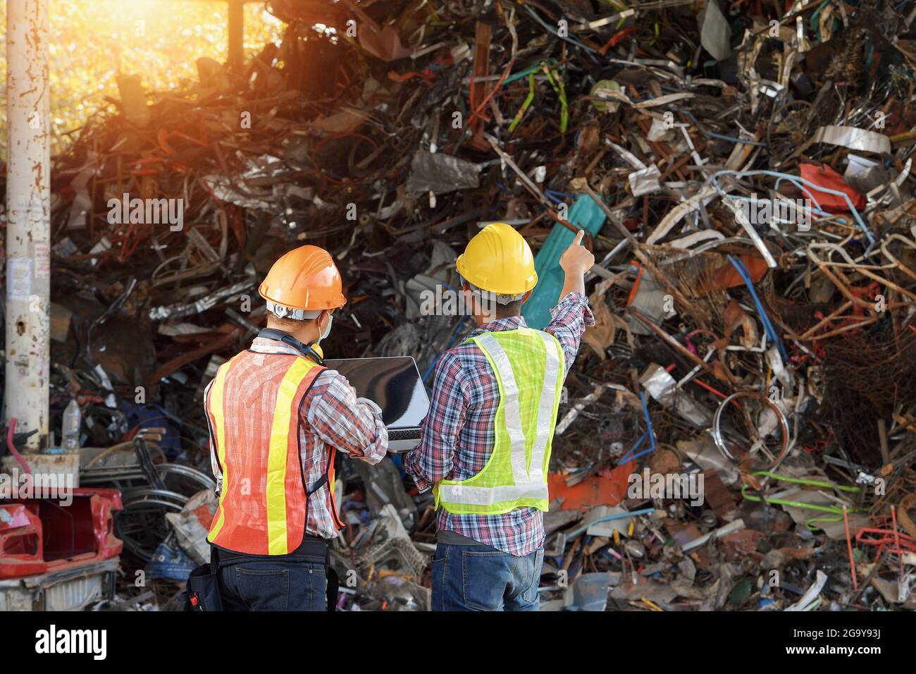 Rear view of two workers at a recycling plant, Thailand Stock Photo