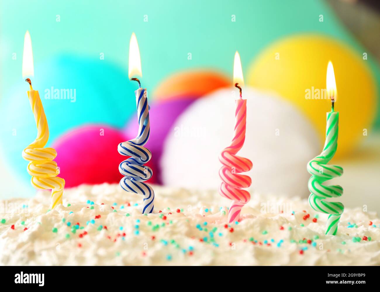 Birthday cake with candles on colorful background Stock Photo - Alamy