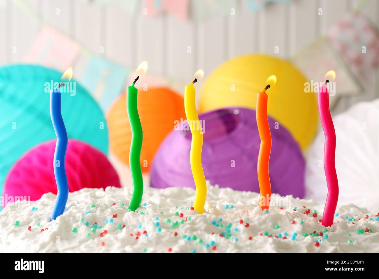 Birthday cake with candles on colorful background Stock Photo - Alamy