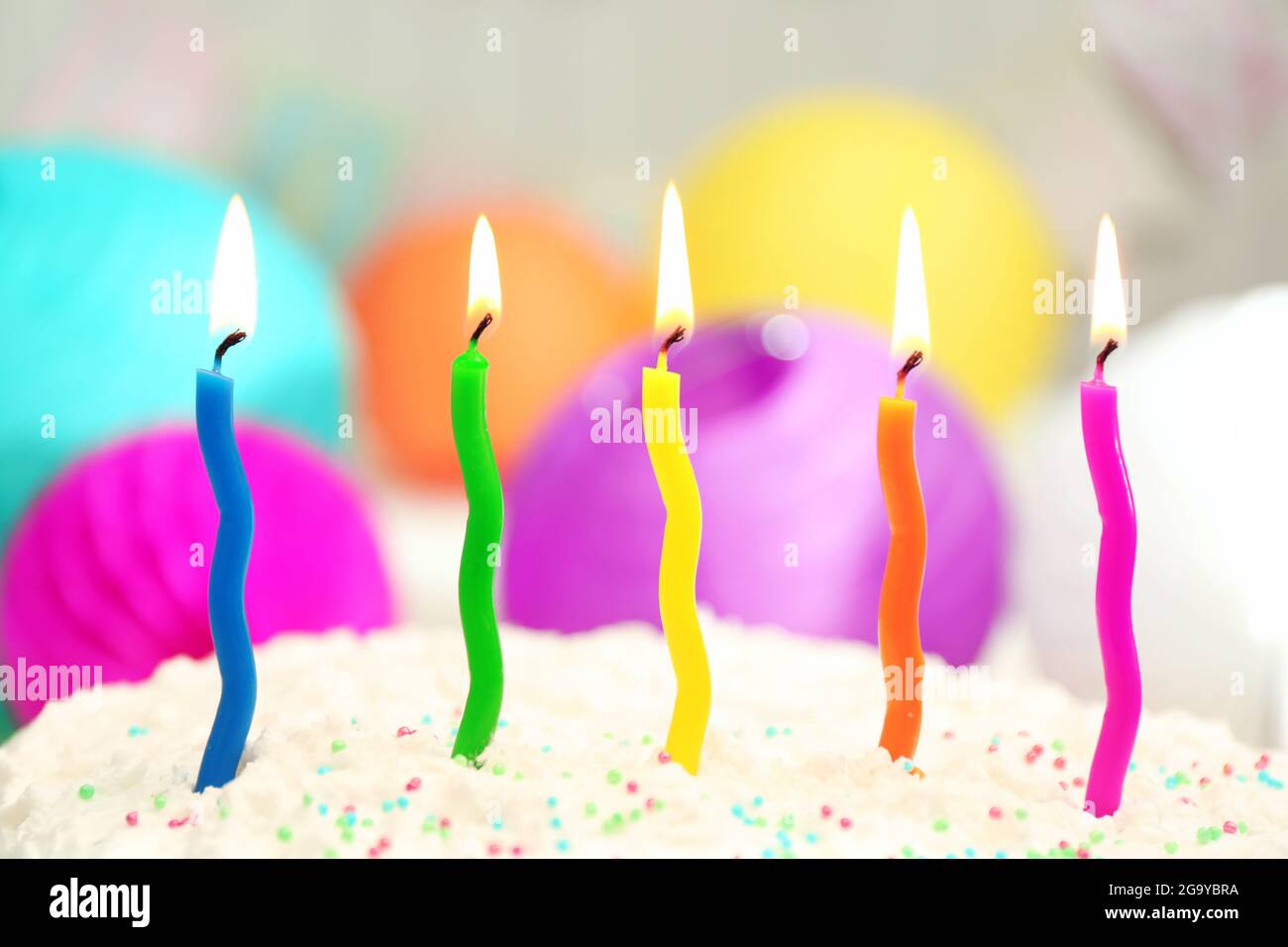 Birthday cake with candles on colorful background Stock Photo - Alamy