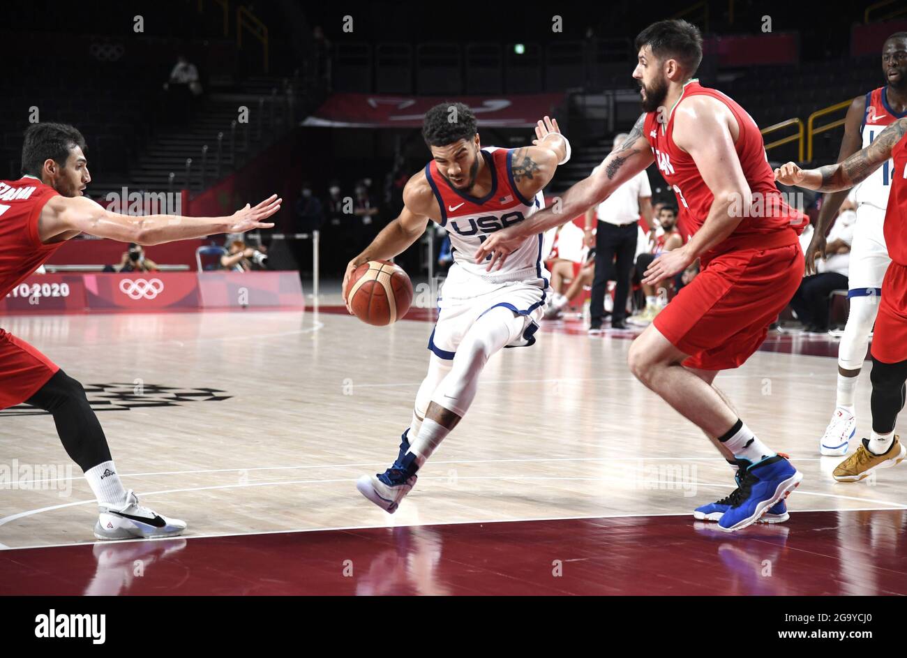 Tokyo, Japan. 28th July, 2021. United States' Jayson Tatum (10) dribbles through Iran's Aaron Geramipoor (R) and Navid Rezaeifar during a Men's Basketball game at the Tokyo 2020 Olympics, Wednesday, July 28, 2021, in Tokyo, Japan. The USA won easily, 120-66. Photo by Mike Theiler/UPI Credit: UPI/Alamy Live News Stock Photo