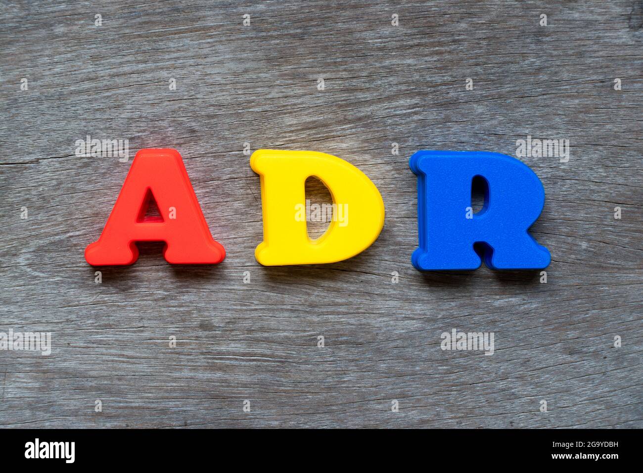 Colorful Plastic Alphabet In Word ADR Abbreviation Of Adverse Drug Reaction On Wood Background 