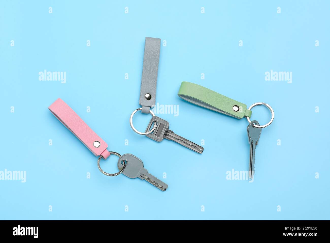 Keys with leather keychains on color background Stock Photo