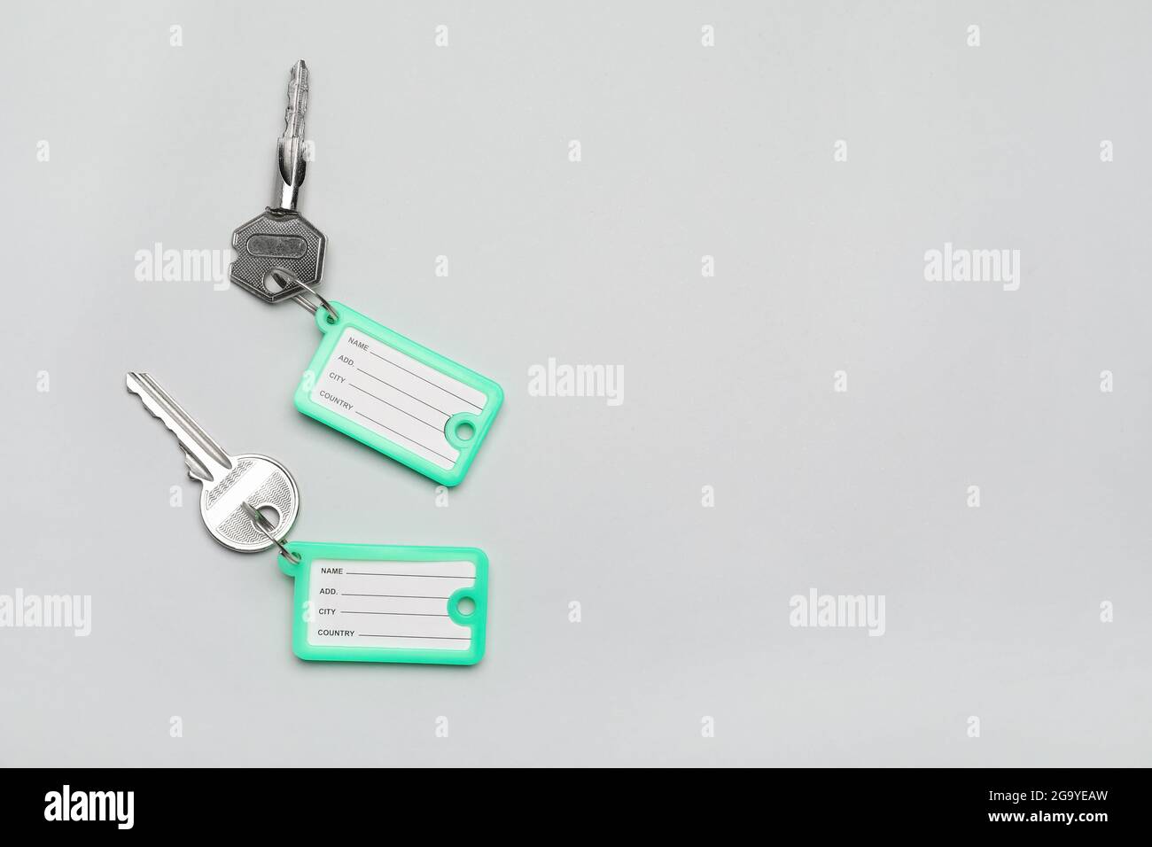 Keys with plastic tags on grey background Stock Photo