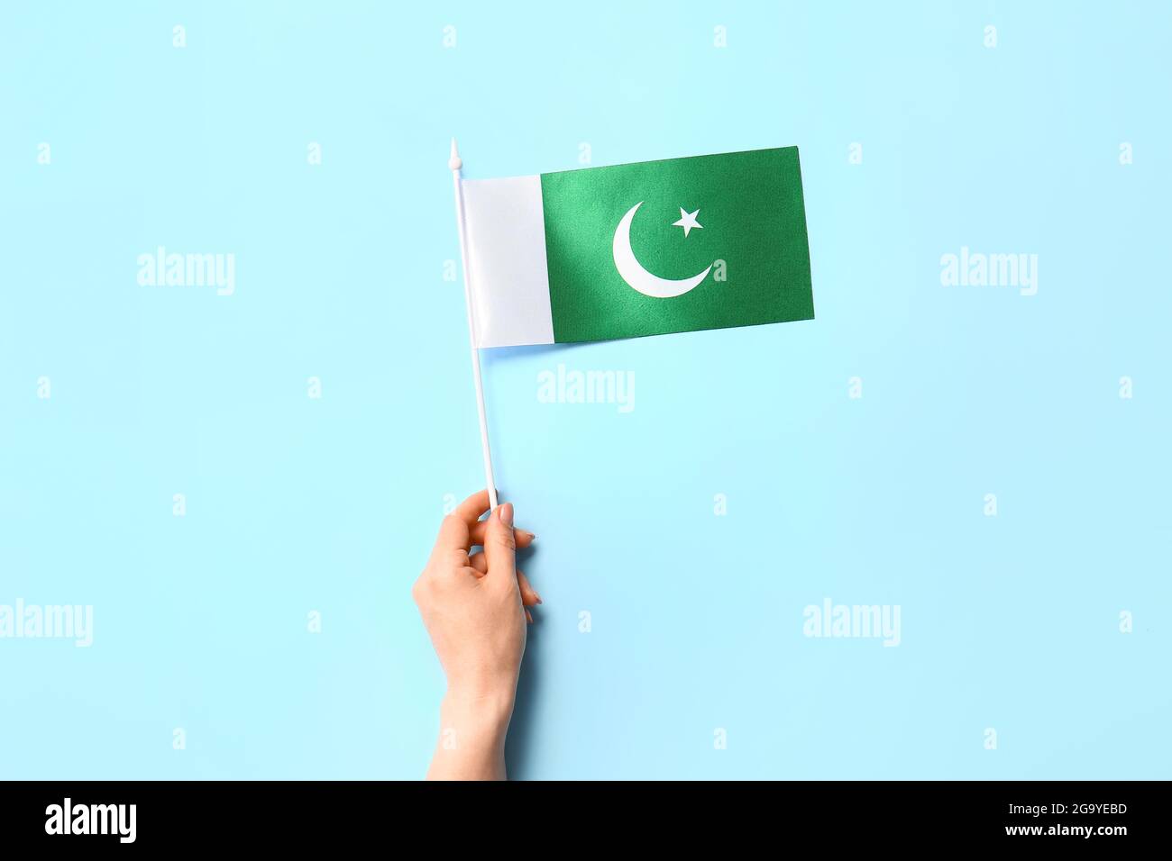 Female hand with Pakistan flag on color background Stock Photo - Alamy