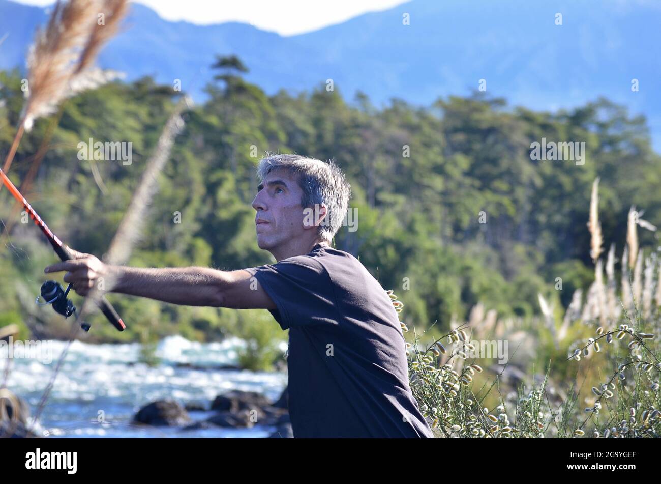 Man standing by a river fishing, Argentina Stock Photo