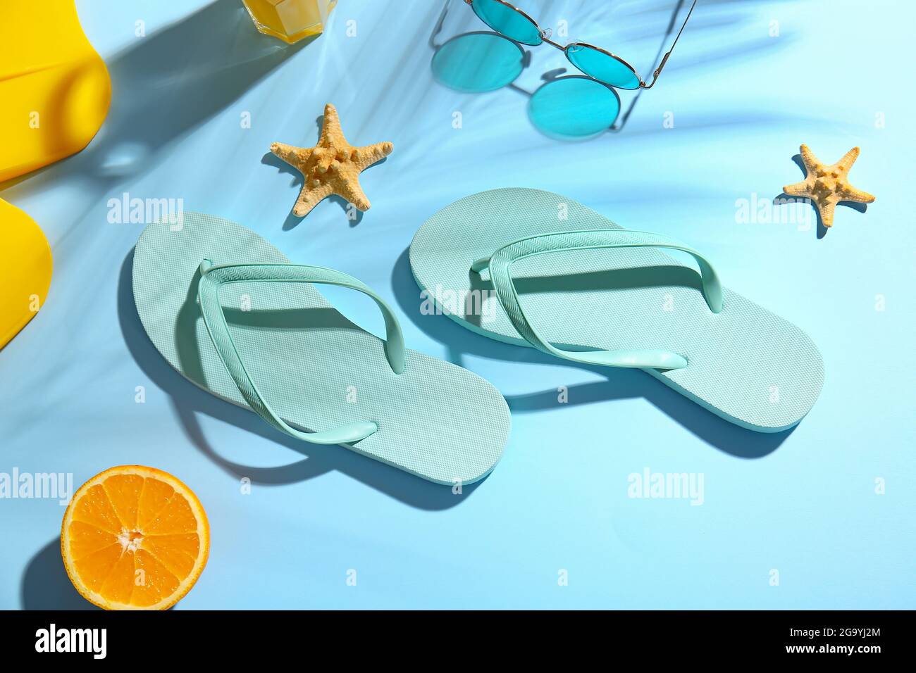 Stylish flip-flops and sunglasses on color background Stock Photo - Alamy