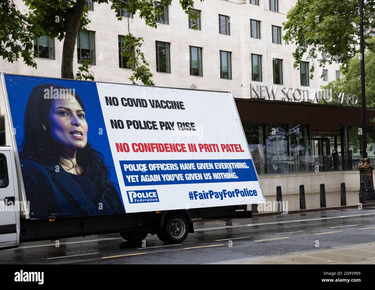 London, UK. 27th July, 2021. An Advertising van outside New Scotland Yard No Covid vaccine, No Police pay rise, No confidence in Priti Patel John Apter, National Chair of the Police Federation of England and Wales and Ken Marsh, Chairman of the Metropolitan Police Federation deliver a letter to 10 Downing Street on behalf of their 130,000 members asking for a pay rise and better conditions Credit: Mark Thomas/Alamy Live News Stock Photo