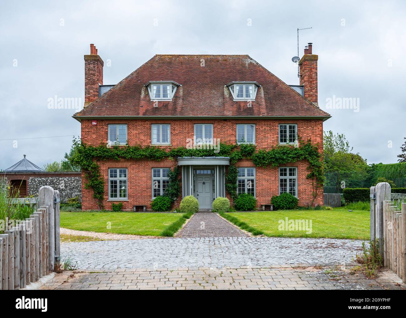 The Red House, a large red brick house in Shore Road in Bosham, West Sussex, England, UK. Stock Photo