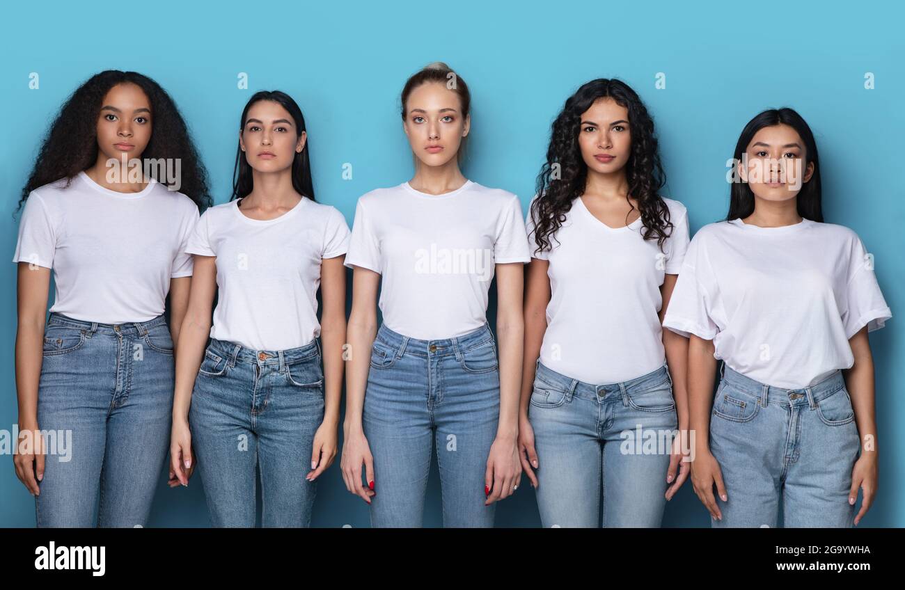 Group Of Serious Multicultural Women Posing Over Blue Background, Panorama Stock Photo