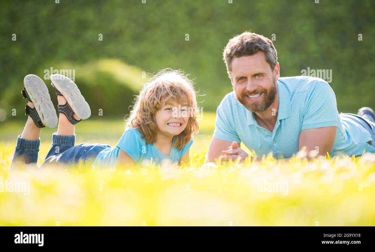 happy family of father and son child relax in summer park green grass, fathering Stock Photo