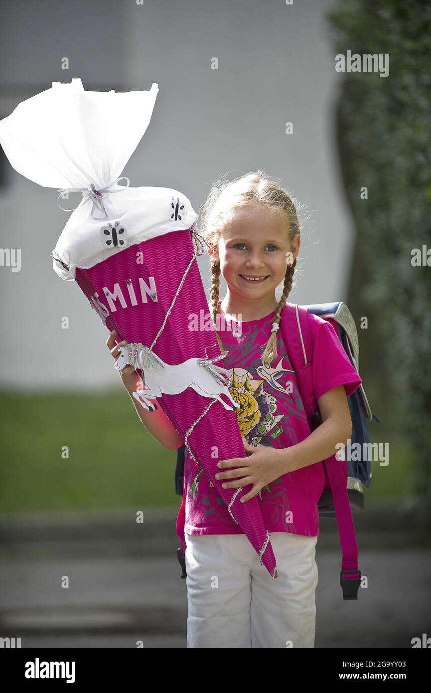 female school beginner with school cone when she start school , Germany Stock Photo
