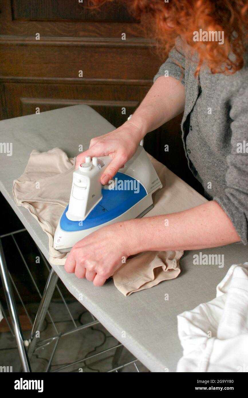 housewife ironing Stock Photo