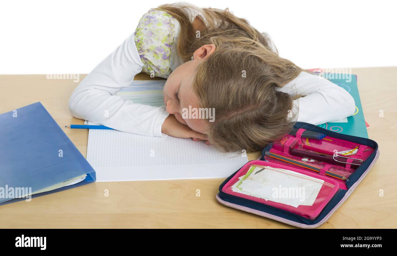 girl doesn't feel like doing homework, sleeping from exhaustion , Germany Stock Photo