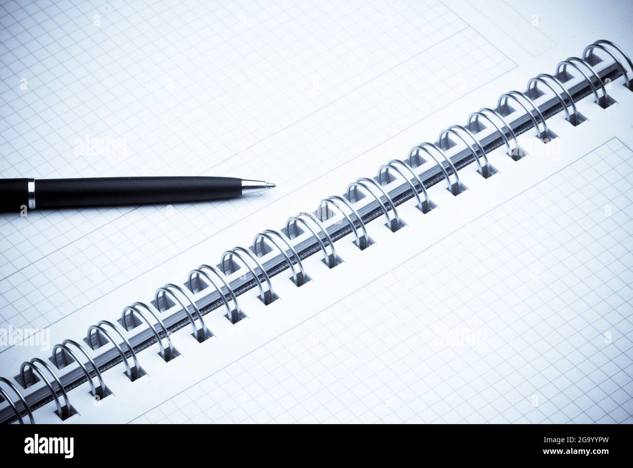 black ballpoint pen on a spiral notebook Stock Photo
