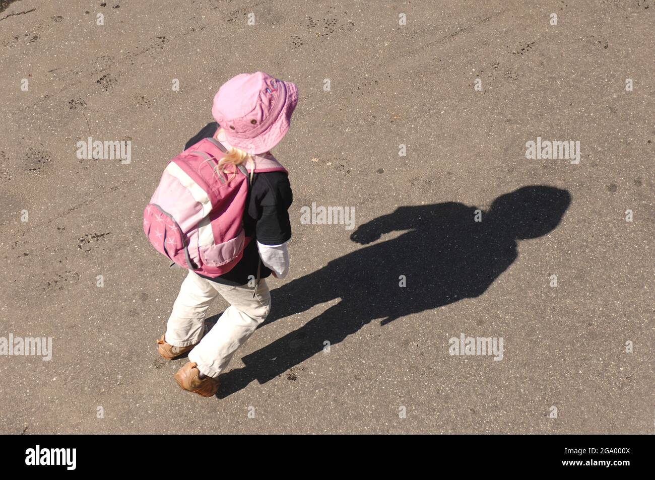 little girl with backpack and sun hat, shadowing , Germany Stock Photo