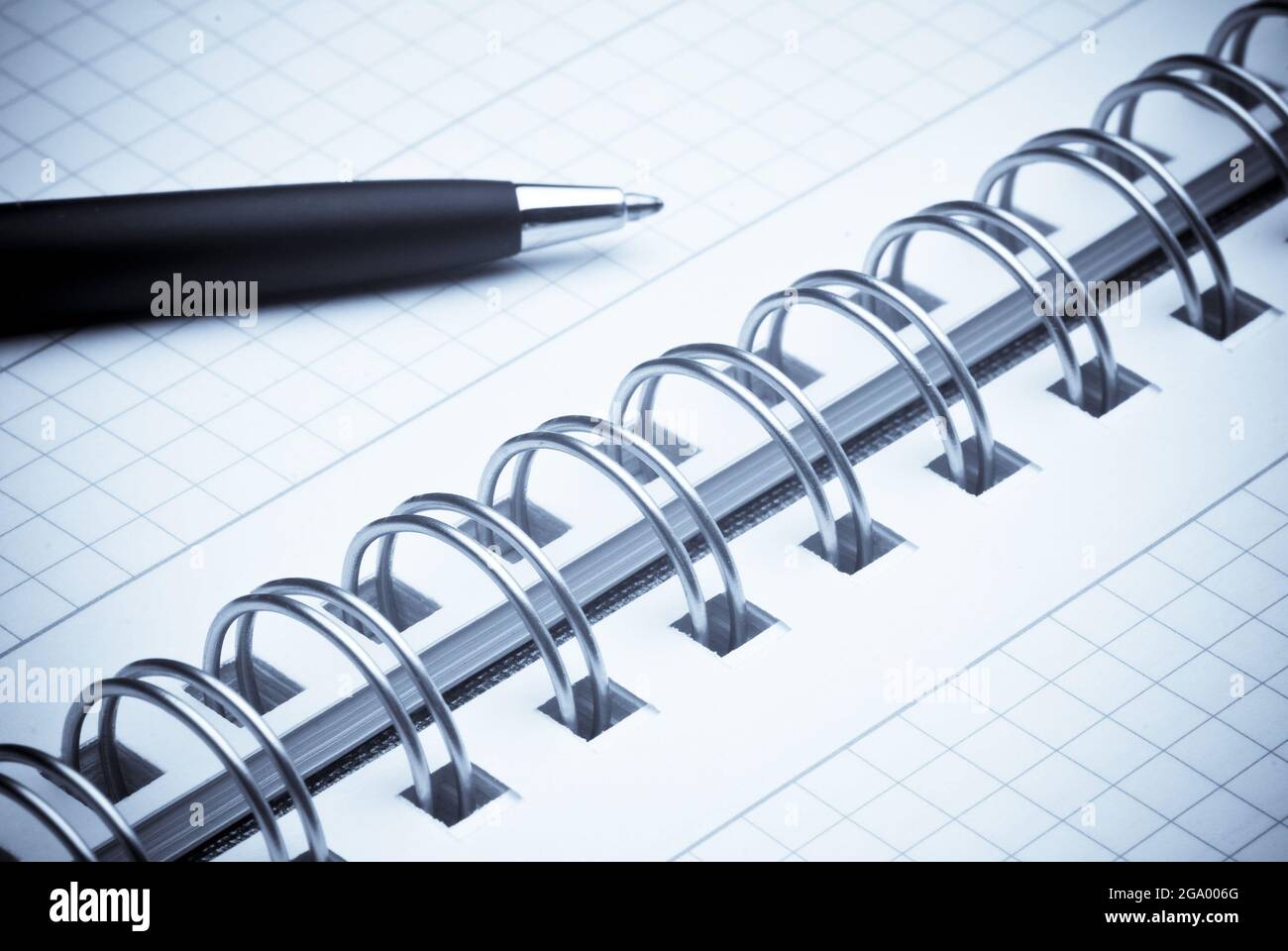 black ballpoint pen on a spiral notebook Stock Photo