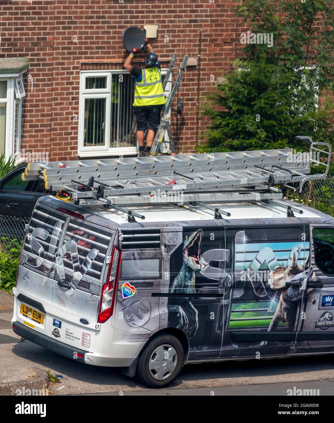 Sky TV Home Installation with van parked on the road . Nottingham. UK Stock Photo