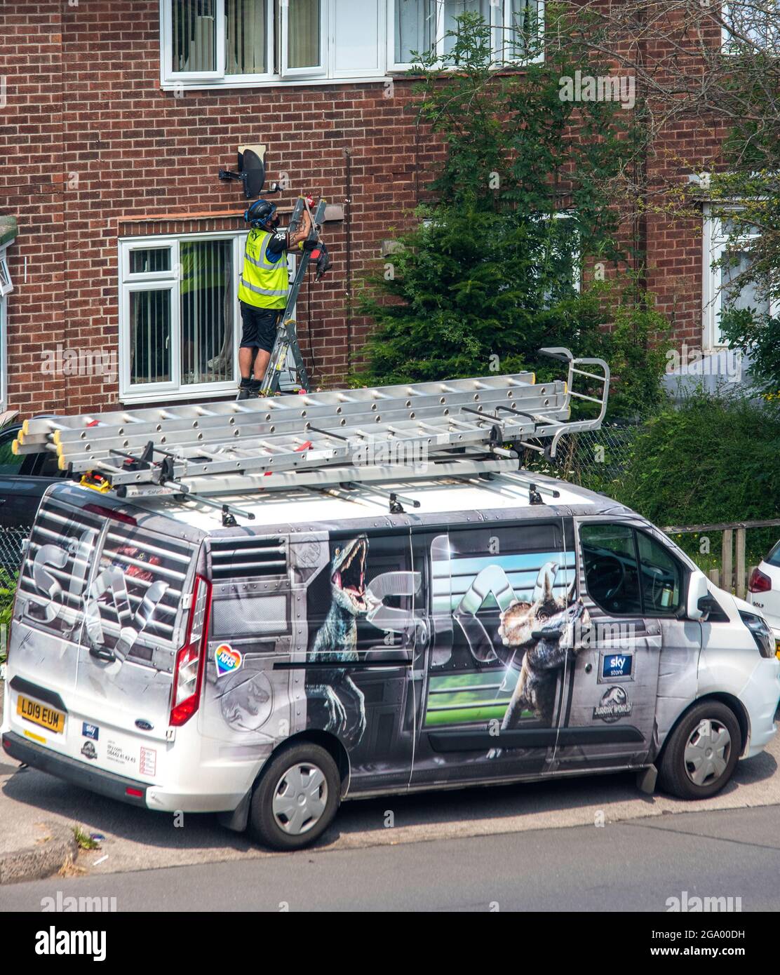 Sky TV Home Installation with van parked on the road . Nottingham. UK Stock Photo