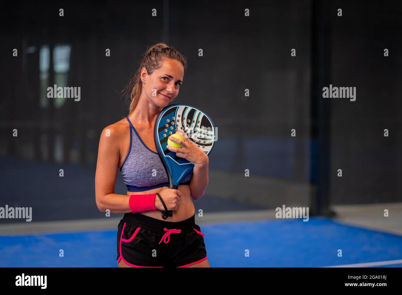 Portrait of beautiful woman playing padel tennis court indoor Stock Photo -  Alamy