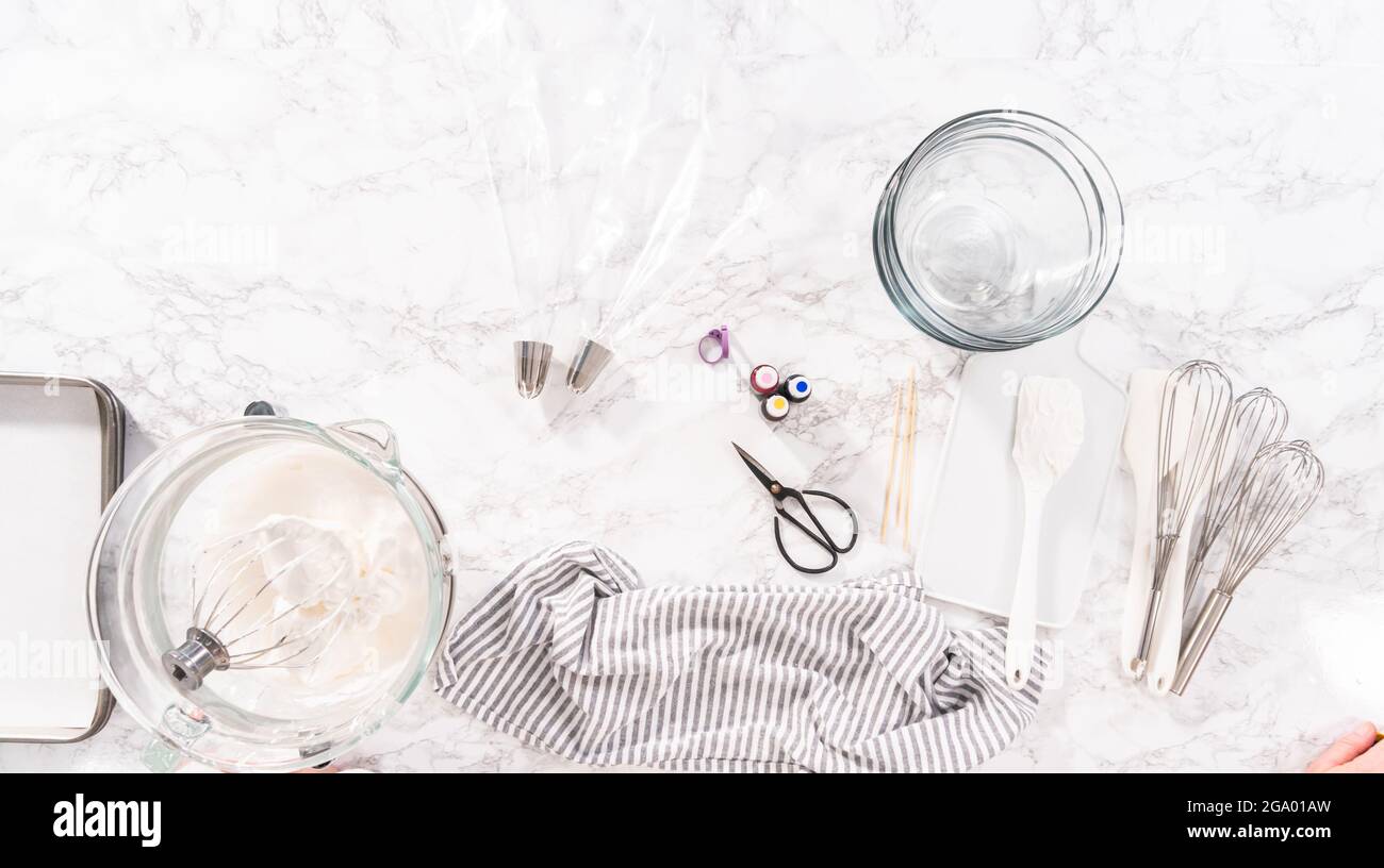 Flat lay. Mixing food coloring into the meringue to bake unicorn