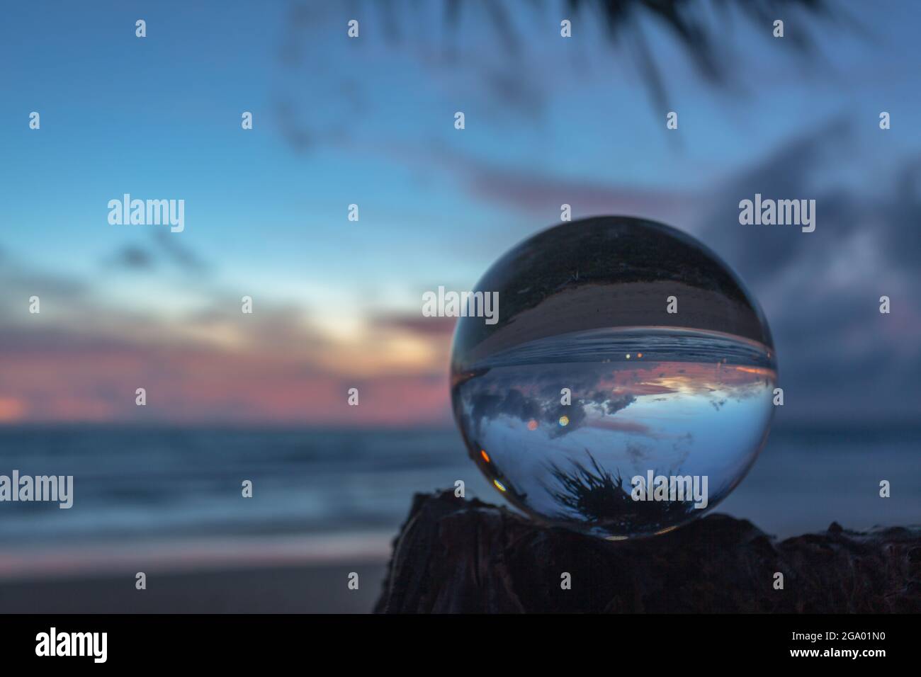 beautiful cloud and golden sunset inside crystal ball placed on a ...