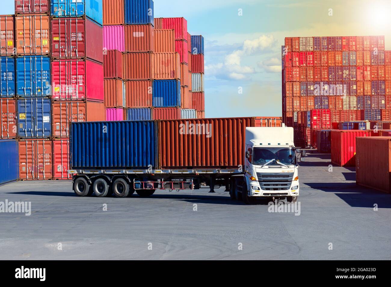 Container truck in cargo yard against blue sky transport background Stock Photo