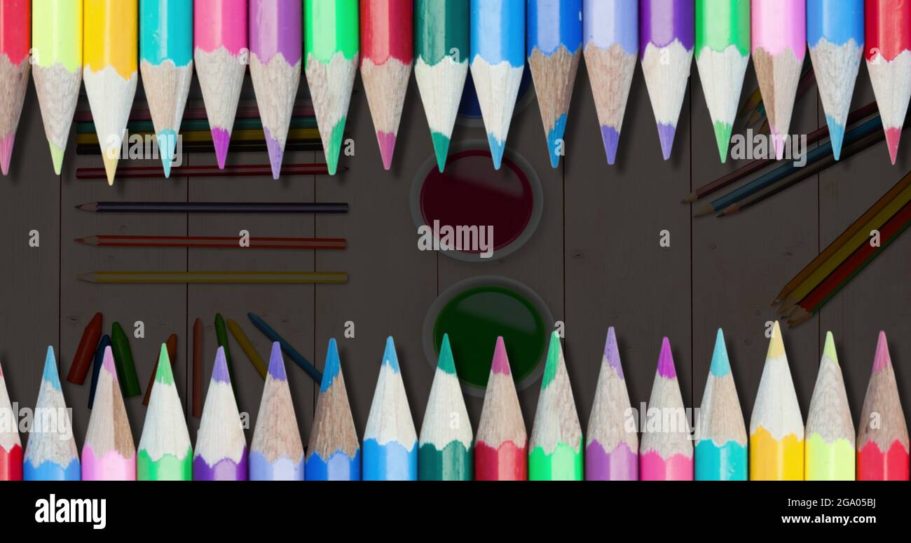 Multiple colored pencils against painting equipment Stock Photo Alamy