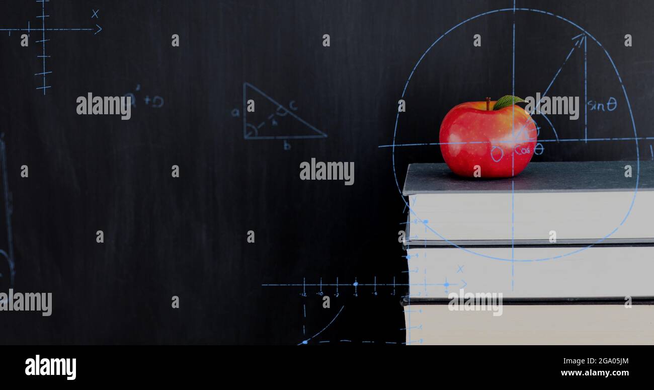 Apple on top of a pile of books and mathematical equations and graphs Stock Photo Alamy