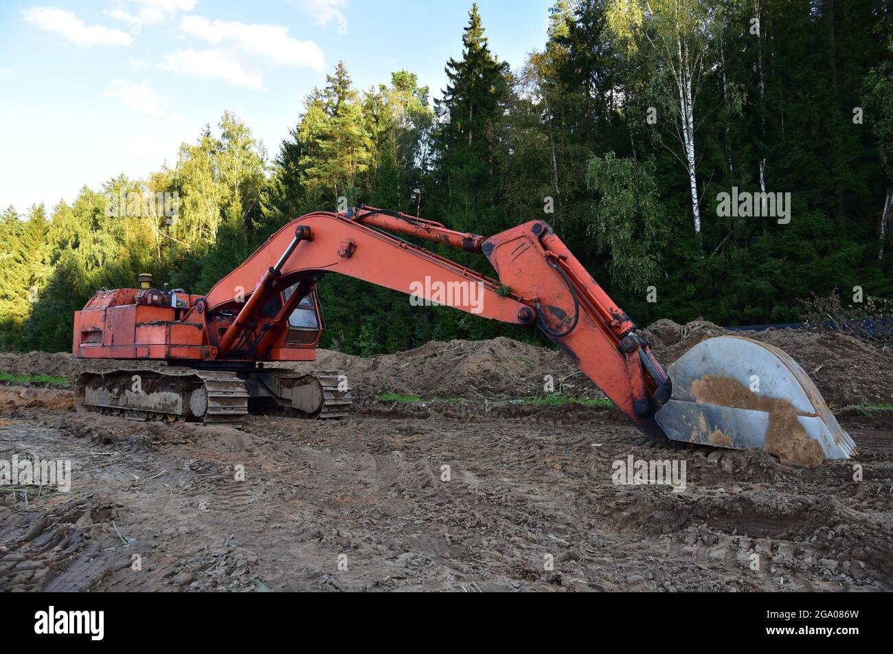 Excavator during groundwork at forest area for construction new road