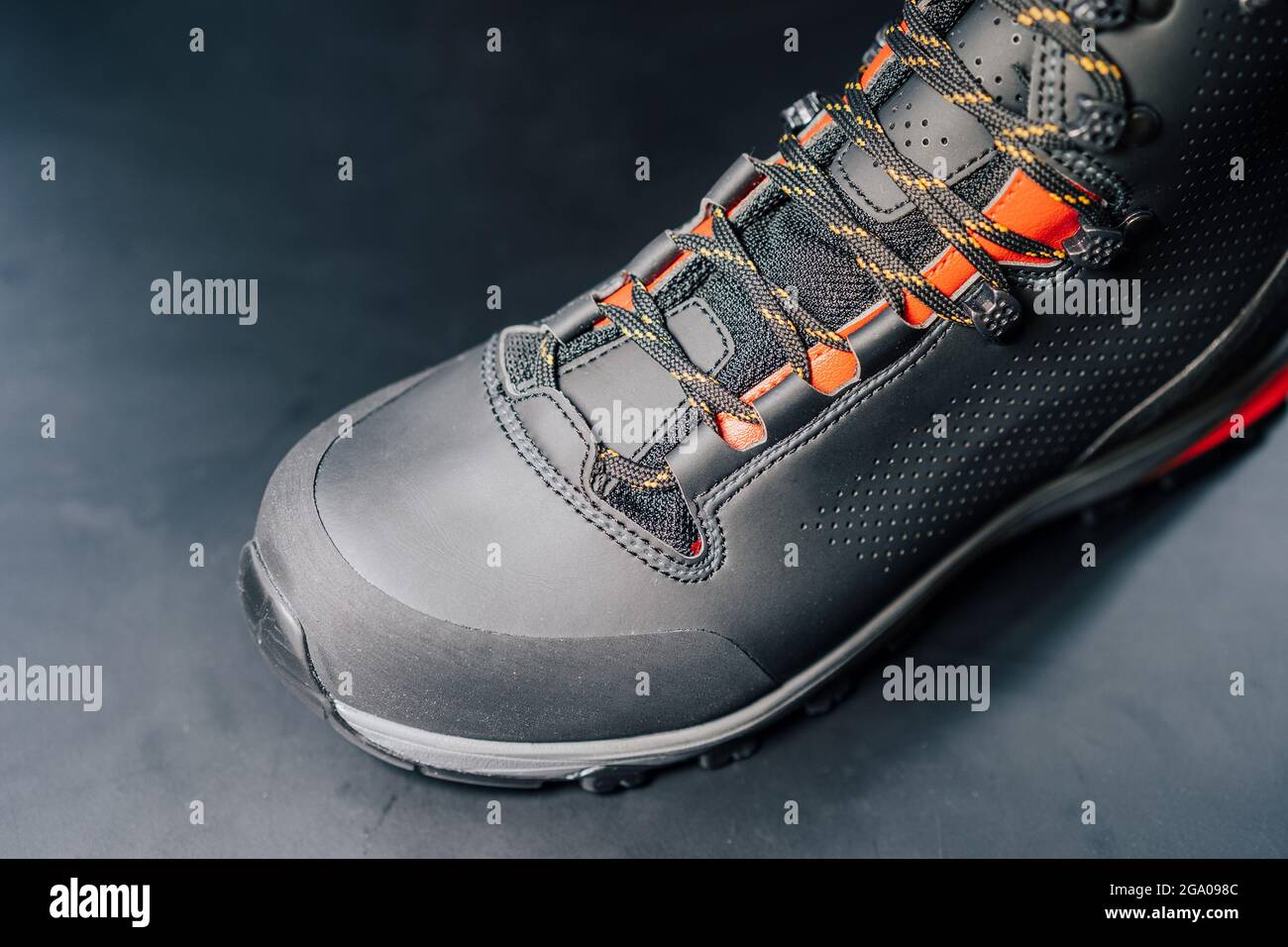 Outdoor boots or hiking shoe on black background Stock Photo - Alamy