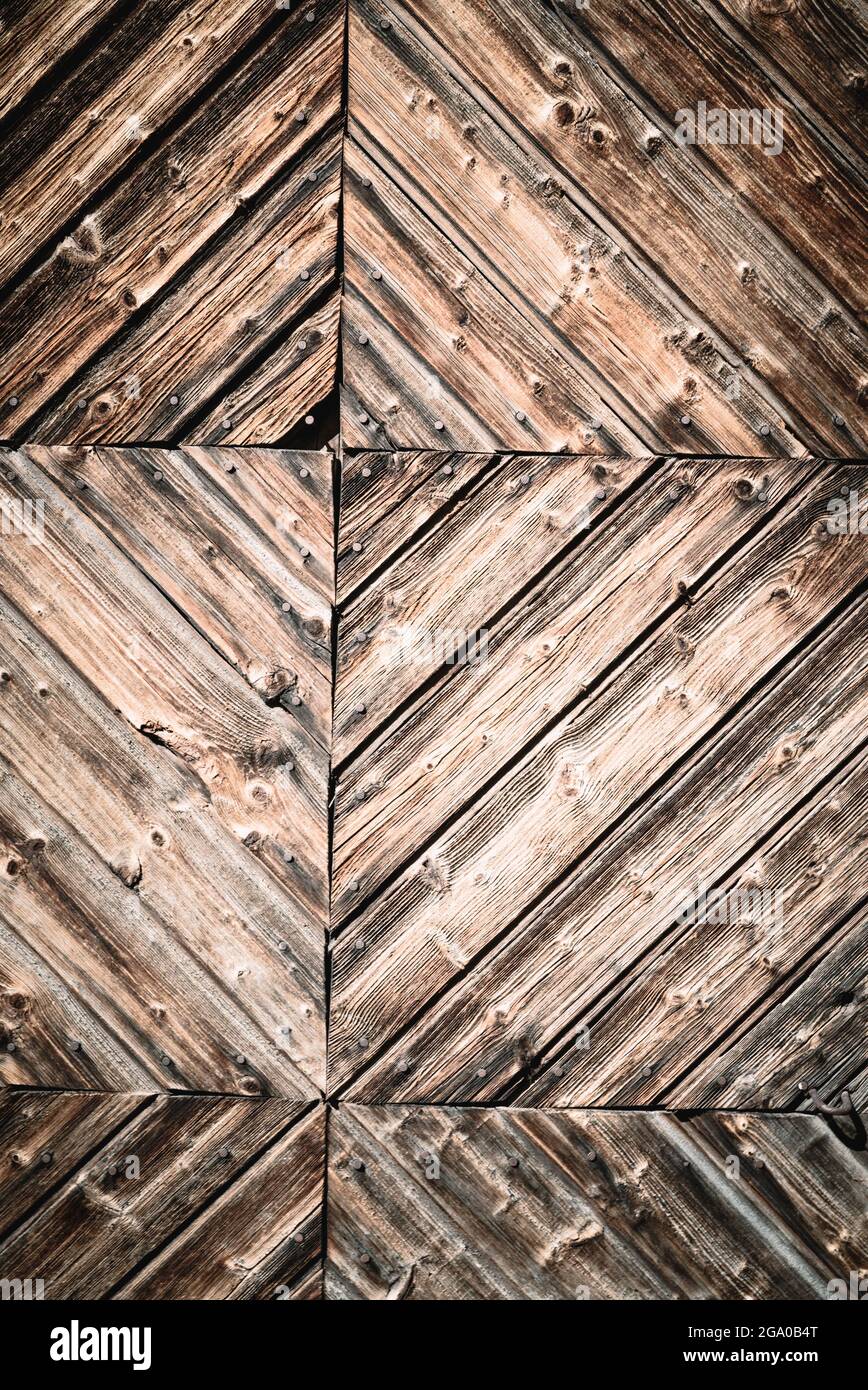 Geometric abstract closeup of natural aged and rural rustic wood surface of recycled weathered planks constructed in creative, decorative lines Stock Photo