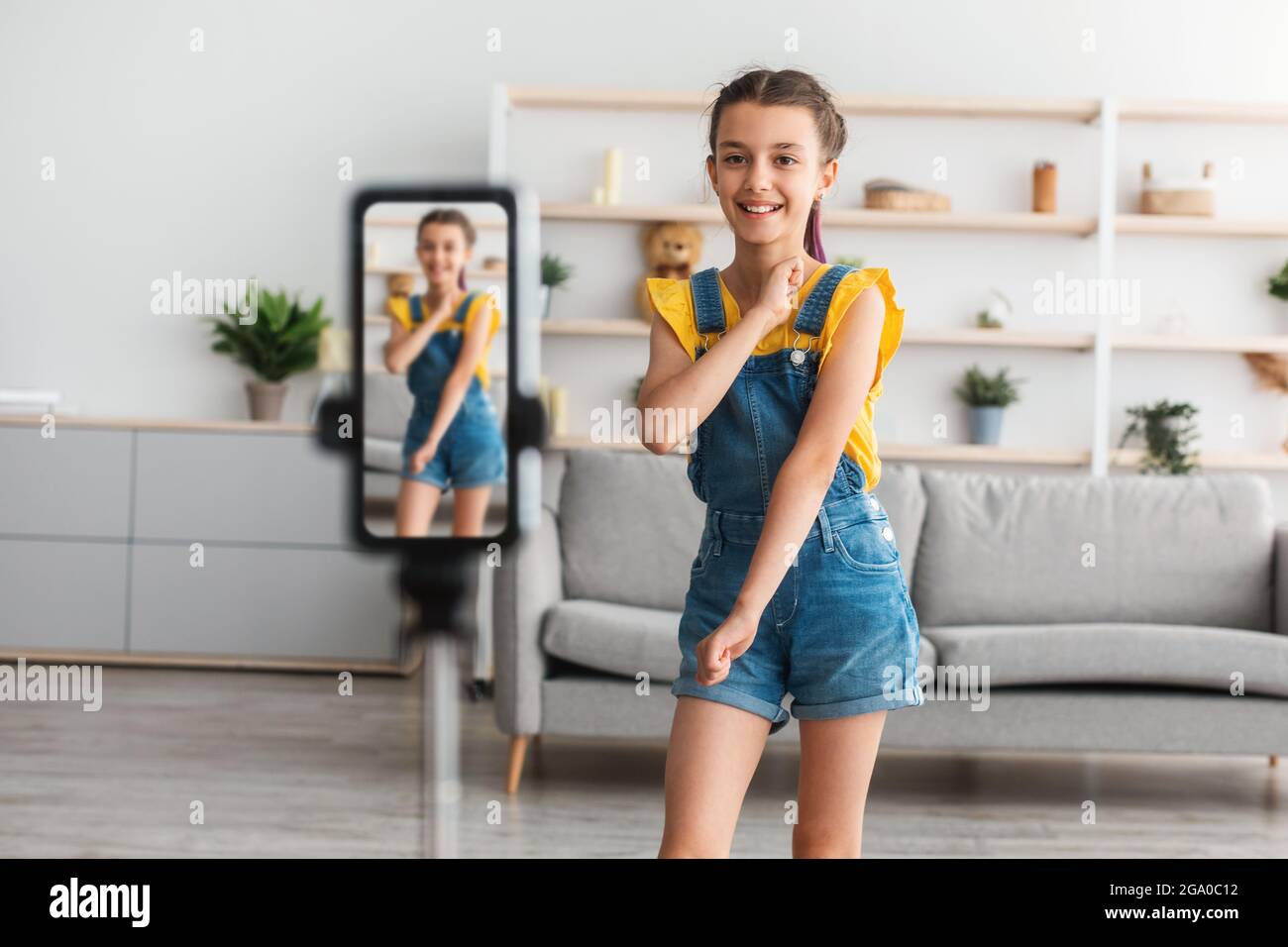 Cheerful teen girl dancing at camera filming video om cellphone Stock Photo  - Alamy