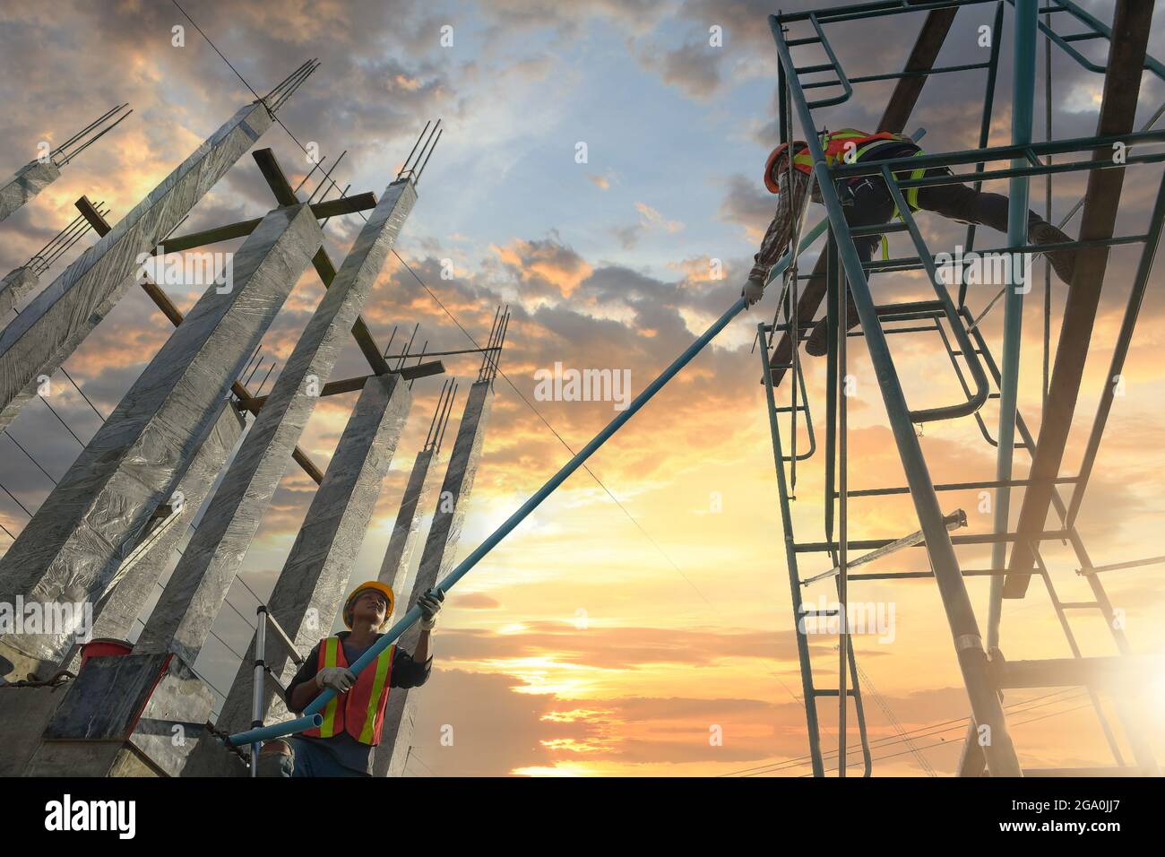 Construction worker wearing safety work at high uniform on scaffolding ...