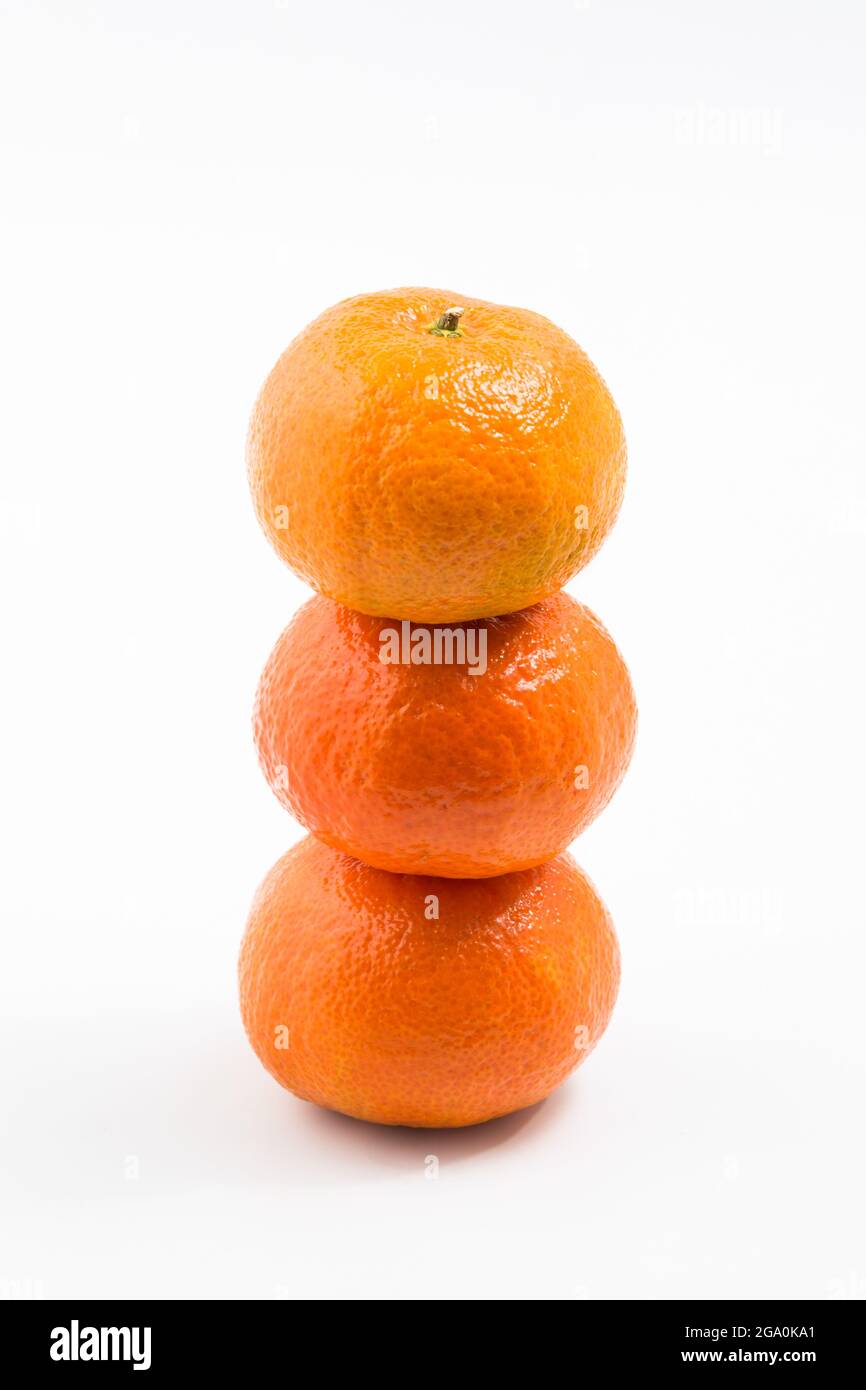 stacked tangerines on white background Stock Photo