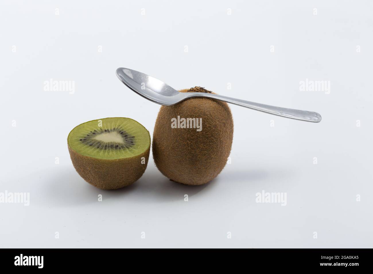 kiwi and spoon on white background Stock Photo - Alamy