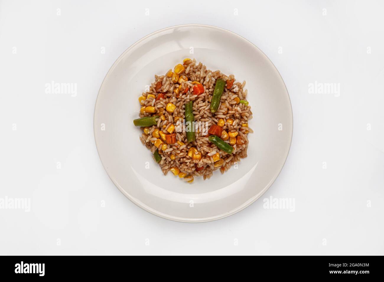 Roasted rice and vegetables on a plate on isolated background Stock ...