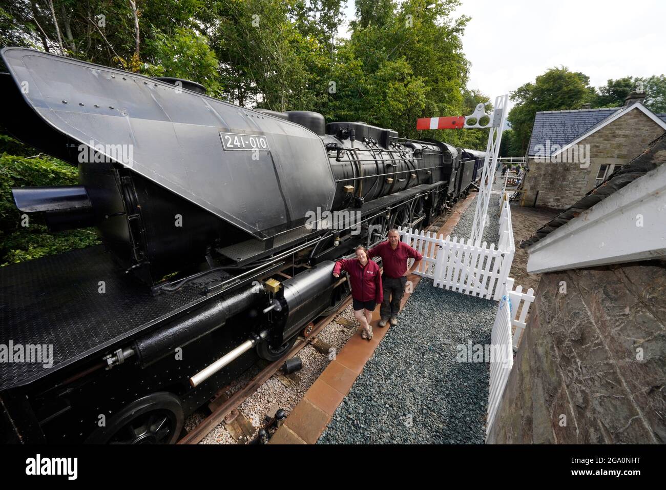 Simon and Diana Parums with their full size steam train with carriages, tracks and platform as they converted and restored Bassenthwaite Lake station in Keswick, offering a dining experience on a Hollywood movie restaurant carriage as its centrepiece, when they open it to the public as an attraction. Picture date: Wednesday July 28, 2021. Stock Photo