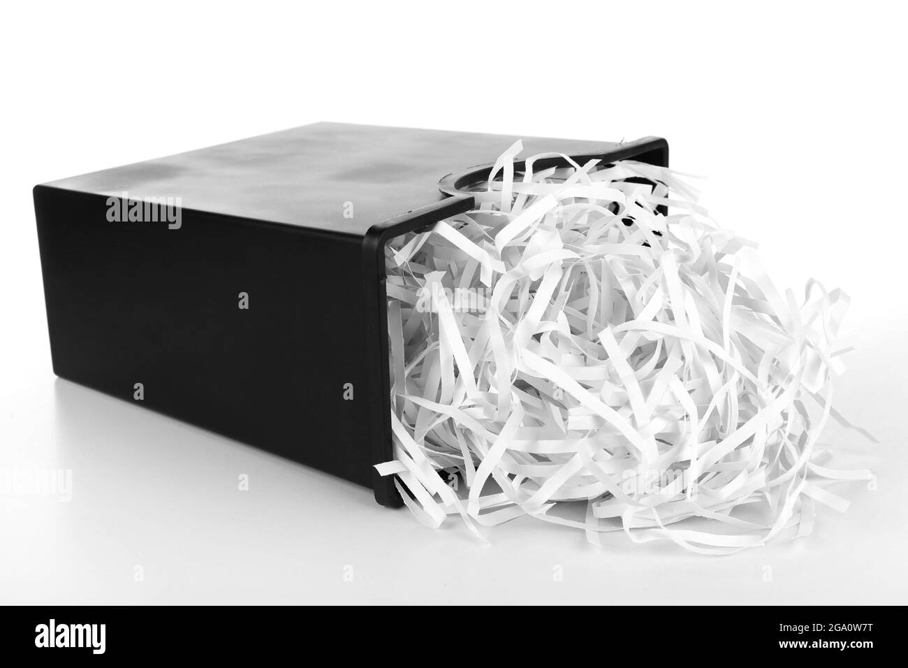 Strips of destroyed paper from shredder in trash can isolated on white
