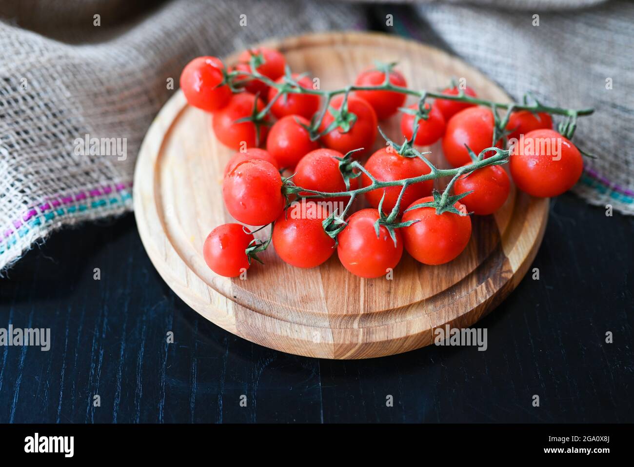delicious vegetables red cherry tomatoes on a branch Stock Photo - Alamy