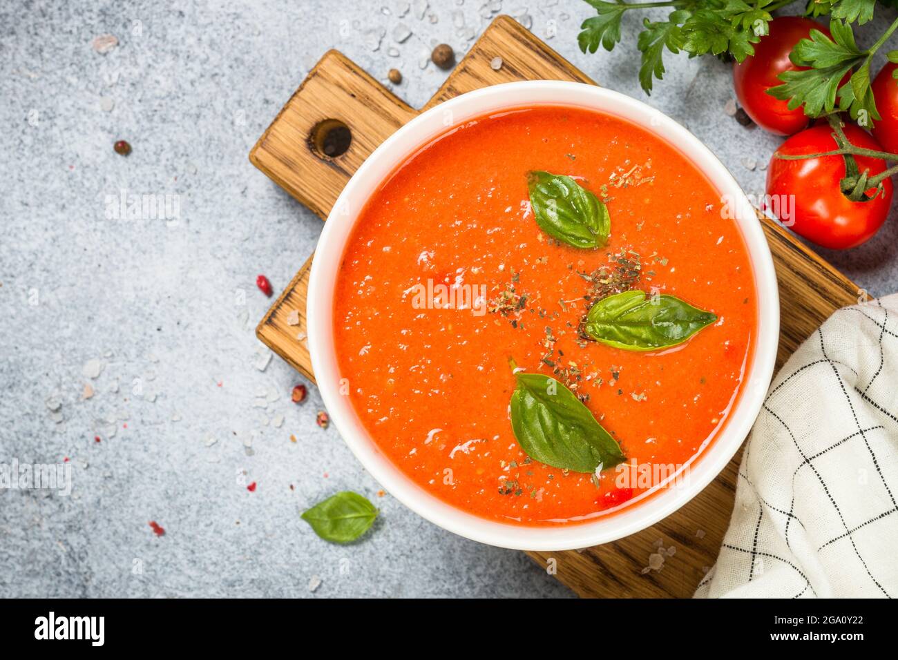 Tomato soup at white table Stock Photo - Alamy