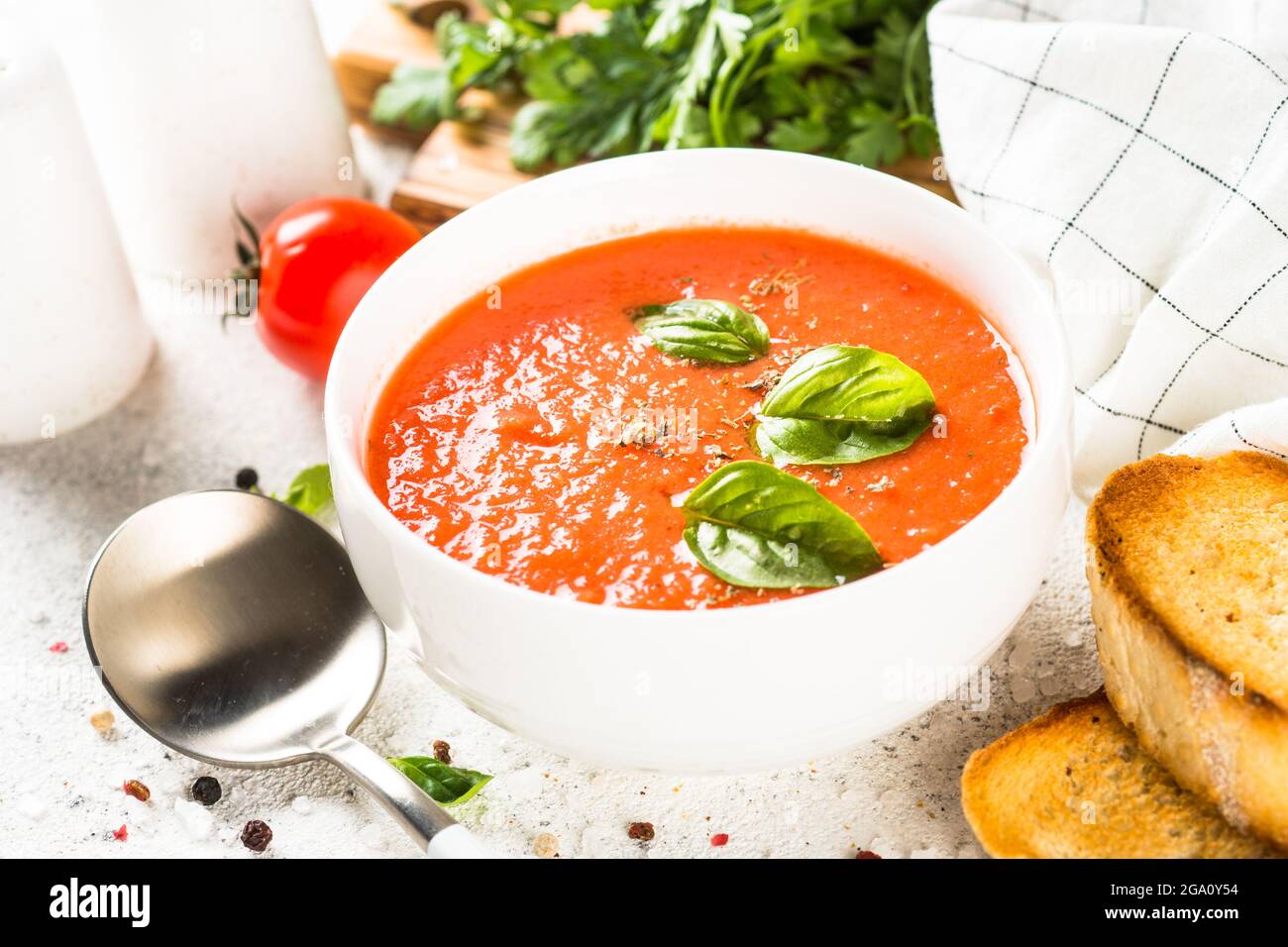 Tomato soup at white table Stock Photo - Alamy