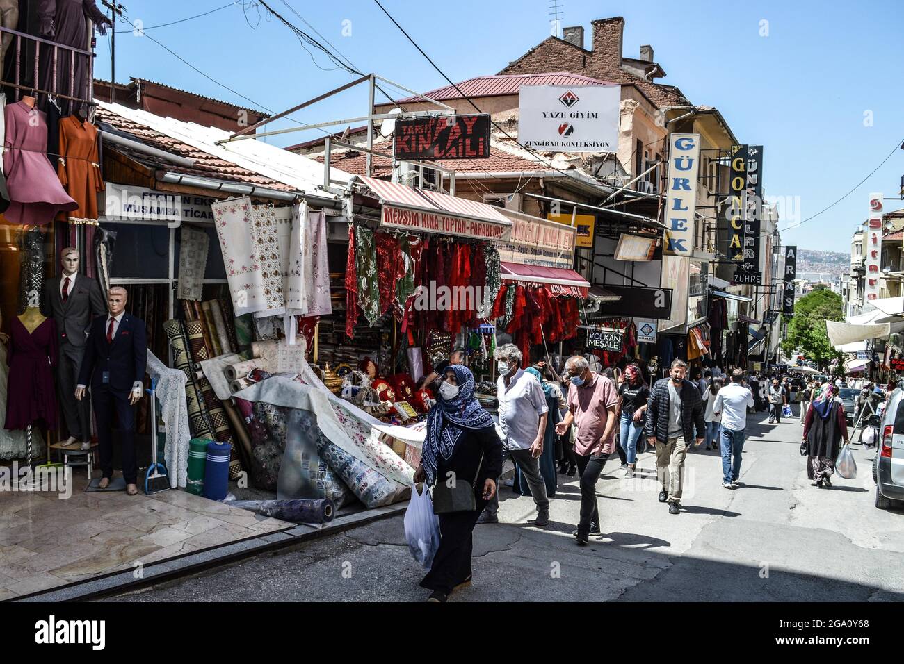 Shoppers wearing protective face masks walk in a bazaar in the historic  district of Ulus during a gradual normalisation period amid the coronavirus  (COVID-19) pandemic in Ankara, Turkey, on Tuesday, May 25,