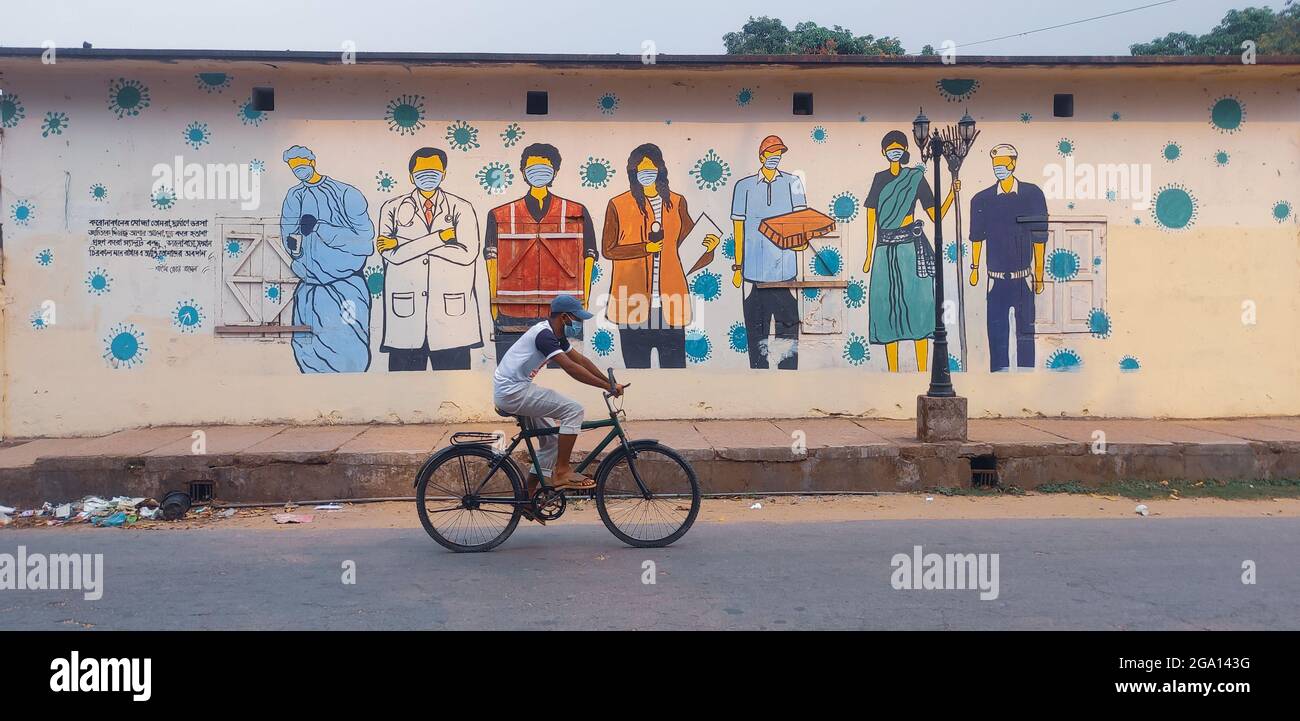 DHAKA, BANGLADESH - Apr 30, 2021: A men riding a bicycle on the street ...