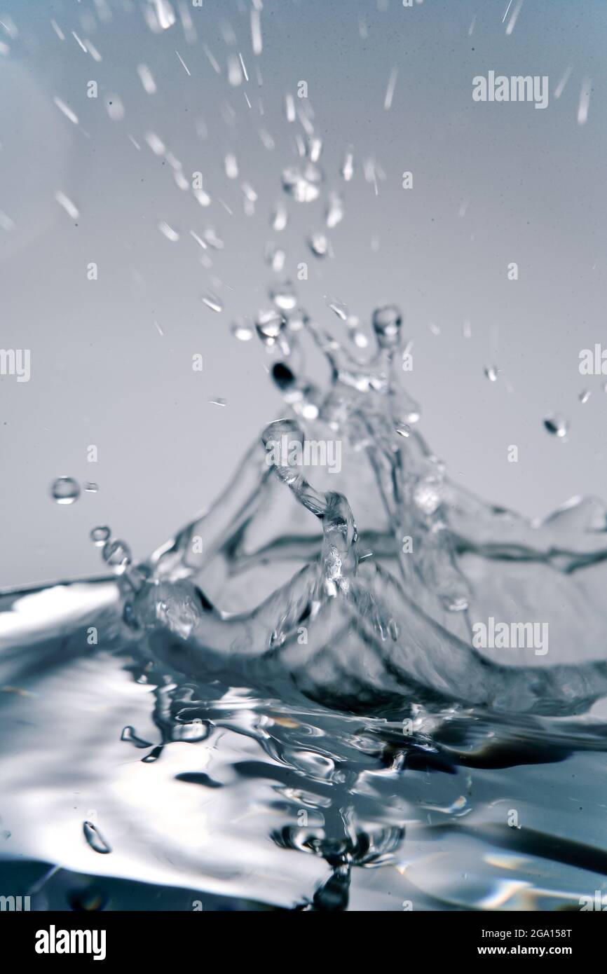 Splashing water with drops. Splash. Water drops, fresh water. Basic elements of environment. Freshness in nature. Clean drinking water on Earth. Stock Photo